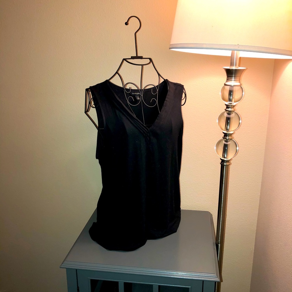 Black decorative v-neck sleeveless top.